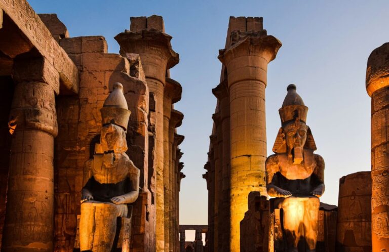 The majestic Luxor Temple bathed in the warm glow of an Egyptian sunset, showcasing its grandeur and historical significance.