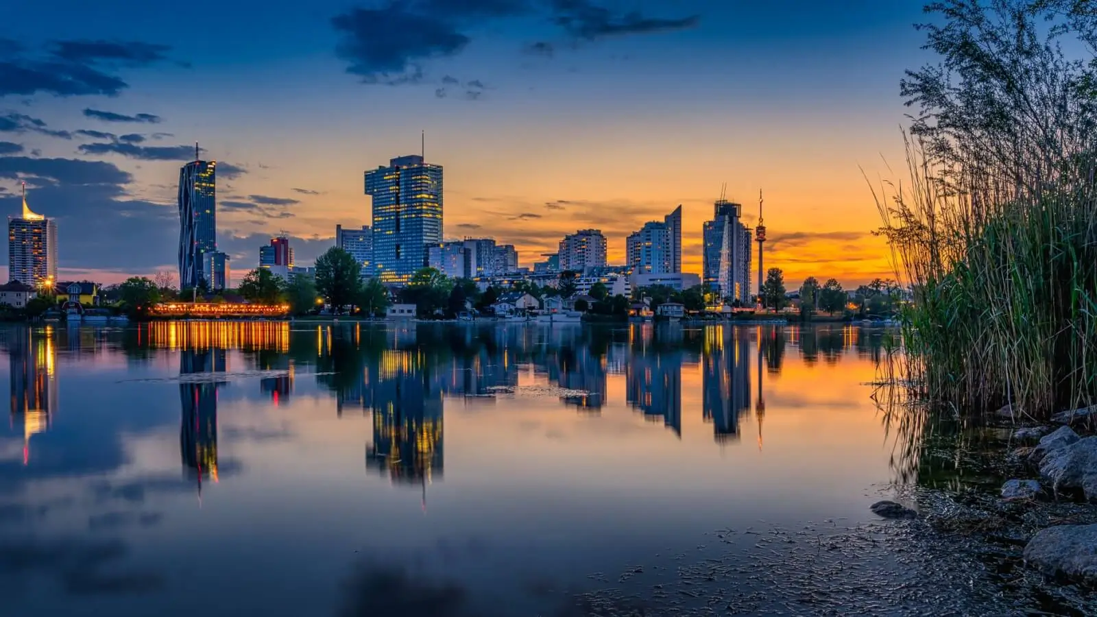 Evening lights reflecting off the Danube River in Vienna, Austria