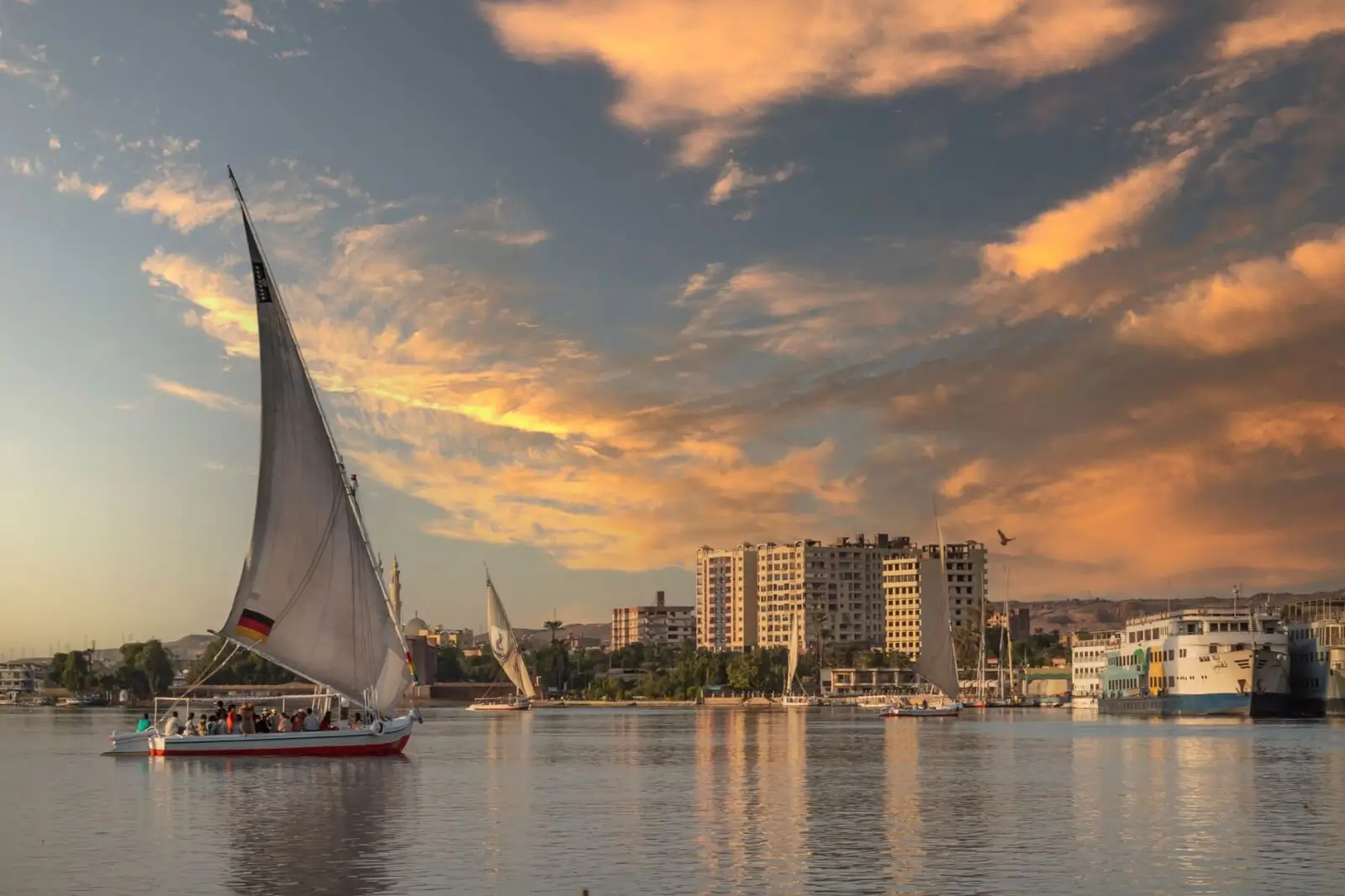 Nile cruise felucca sunset reflection Egypt