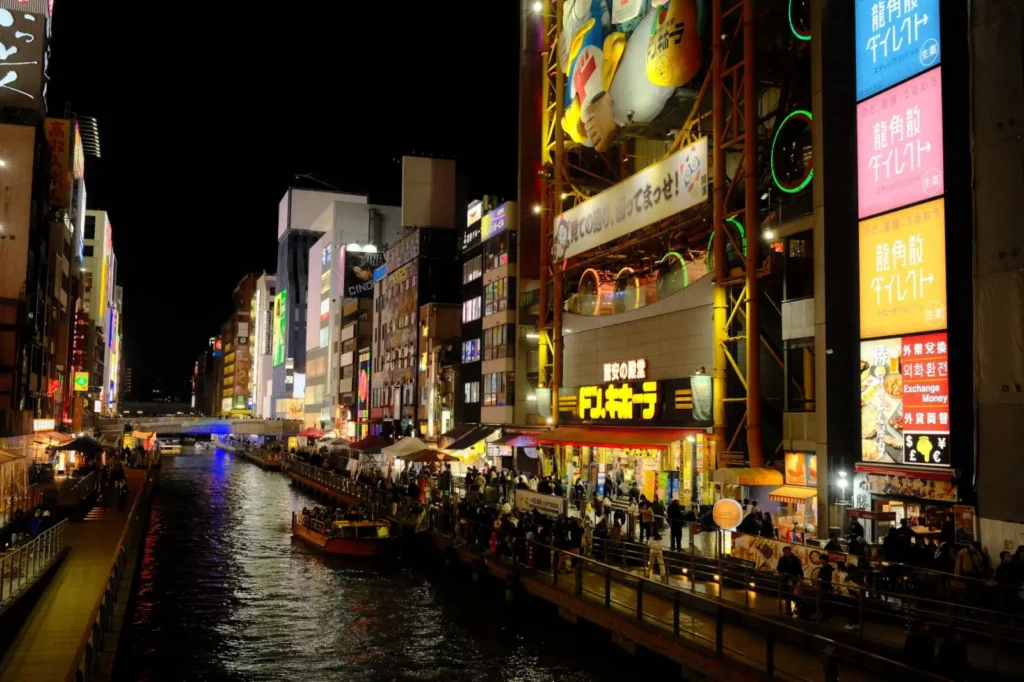 The lively atmosphere of Osaka's Dotonbori street food market at night